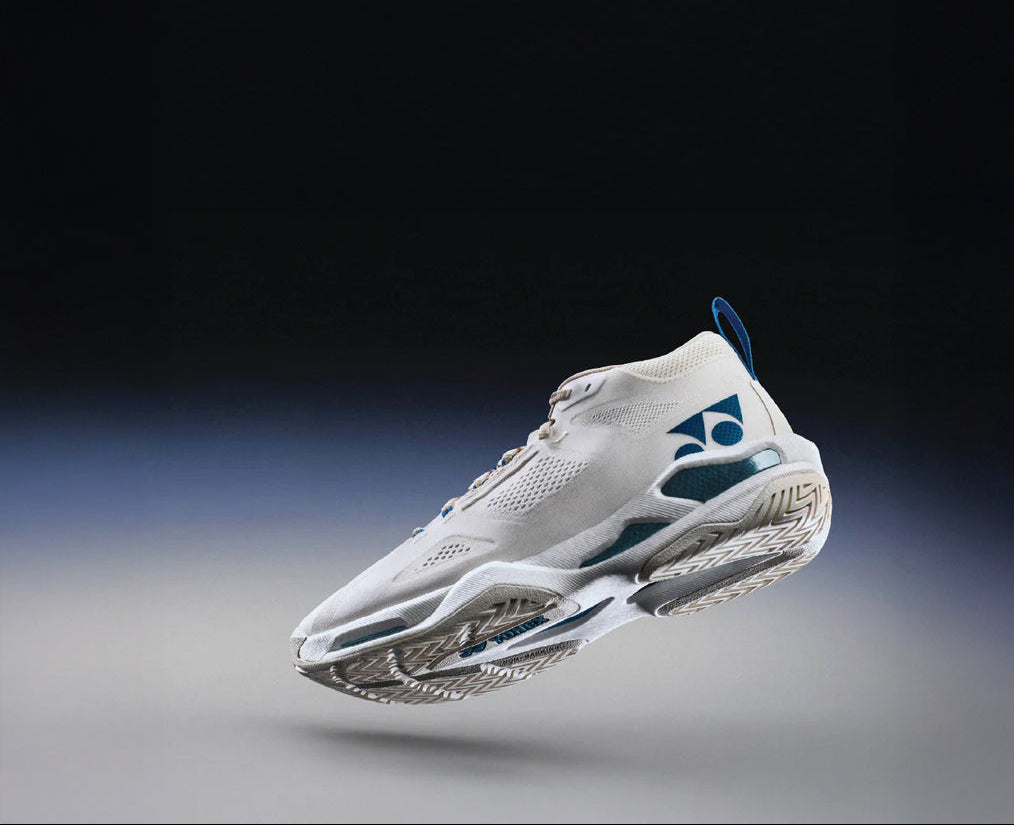 White athletic shoe with a brand logo on a gradient background